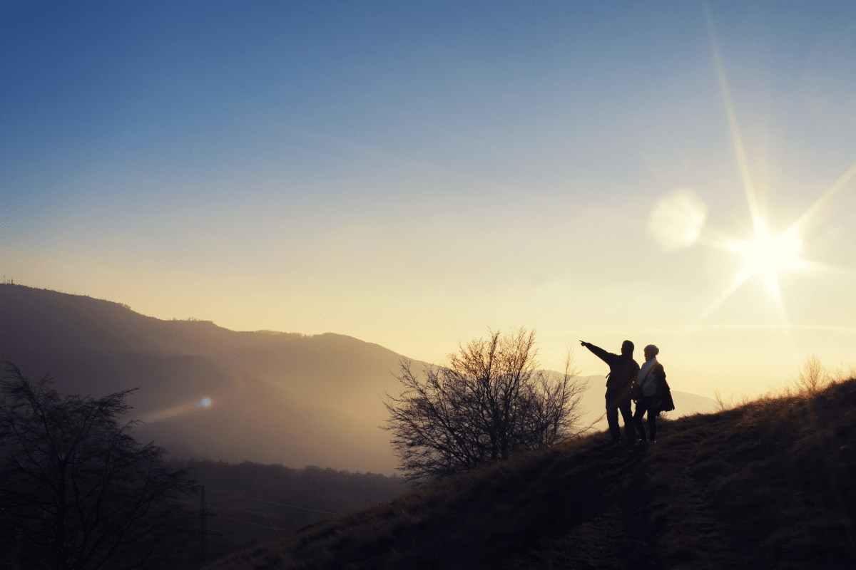 couple hiking at sunrise